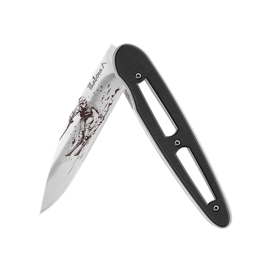 Couteau acier finition brillante plaquette ajourée résine g10 noir motif «skieur»
