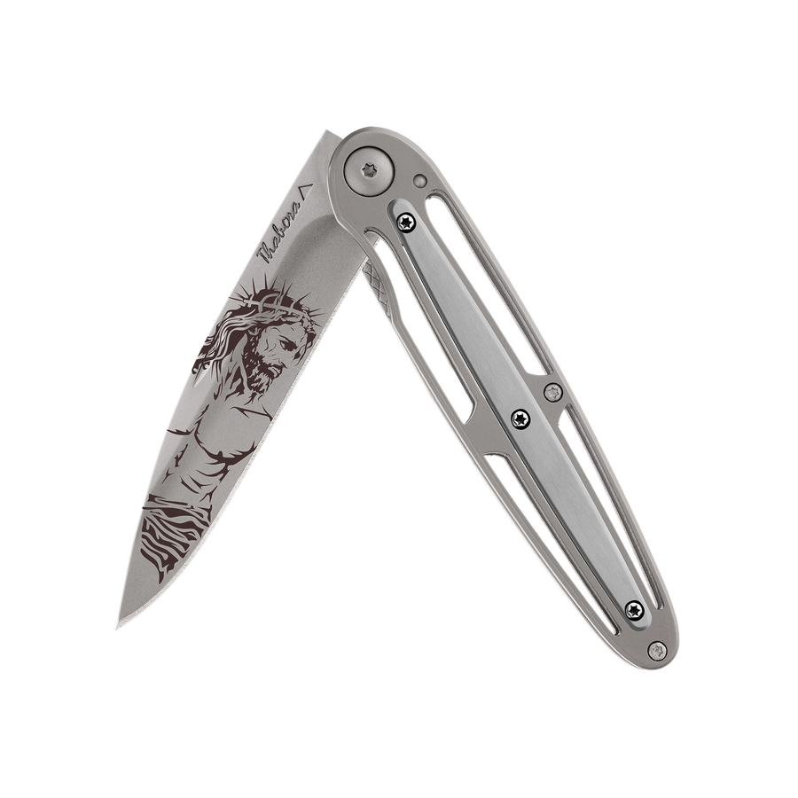 Couteau acier finition titane gris plaquette centrale acier brossé motif «christ»