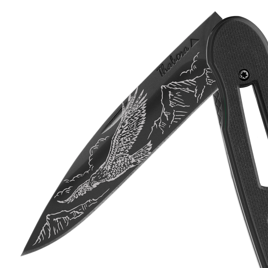 Couteau acier finition titane noir plaquette ajourée résine g10 noir motif «aigle»