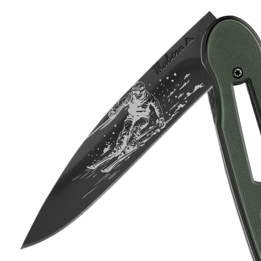 Couteau acier finition titane noir plaquette ajourée résine g10 kaki motif «skieur»