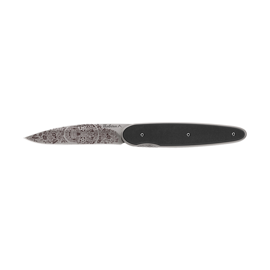 Couteau acier finition titane gris plaquette pleine résine g10 noir motif «tête mexicaine»