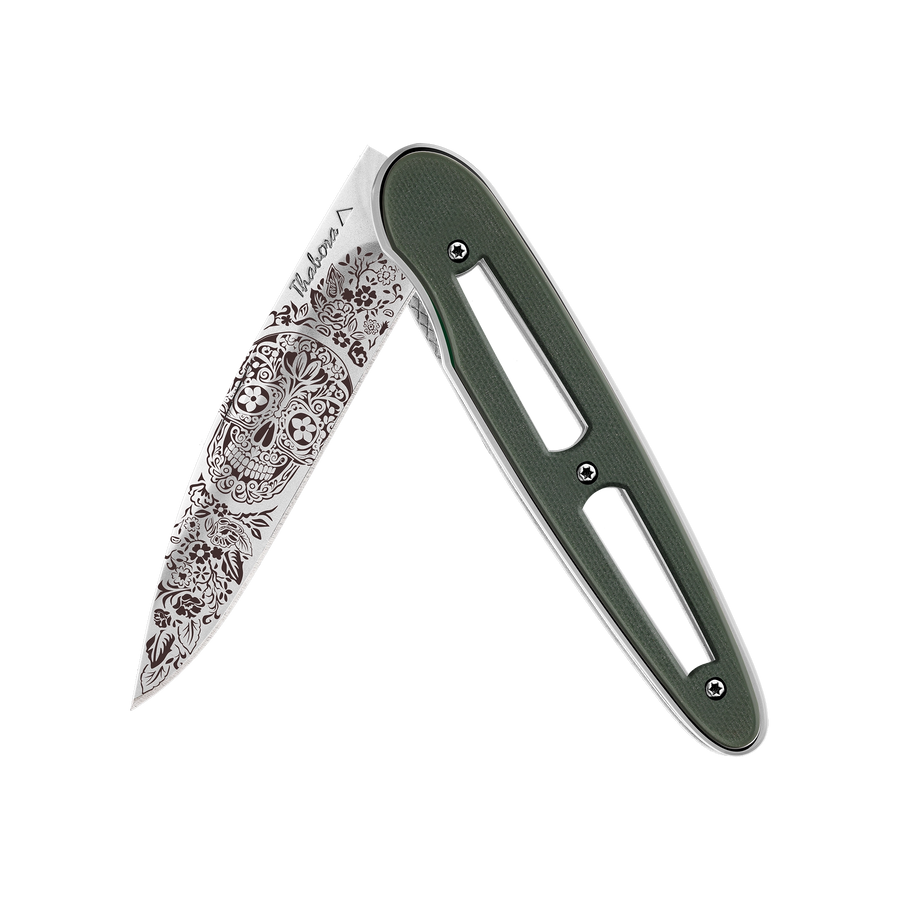 Couteau acier finition brillante plaquette ajourée résine g10 kaki motif «tête mexicaine»