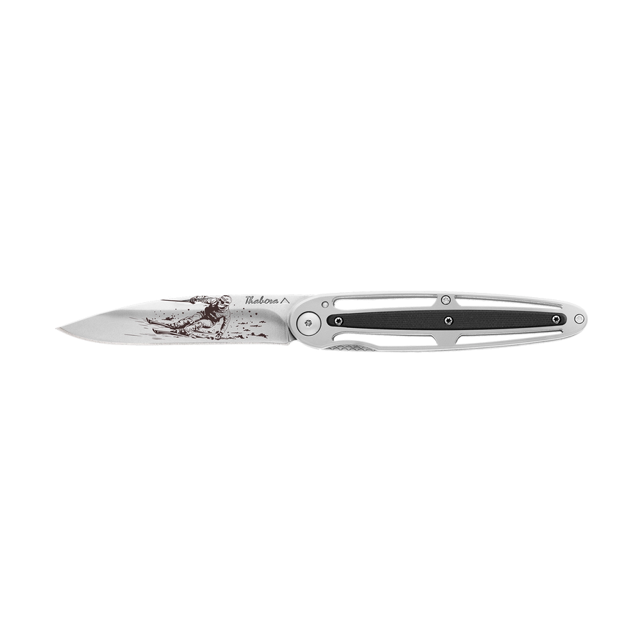 Couteau acier finition brillante plaquette centrale résine g10 noir motif «skieur»