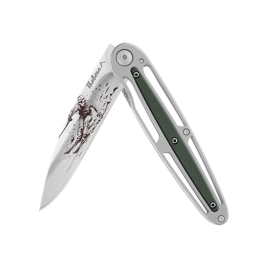 Couteau acier finition brillante plaquette centrale résine g10 kaki motif «skieur»