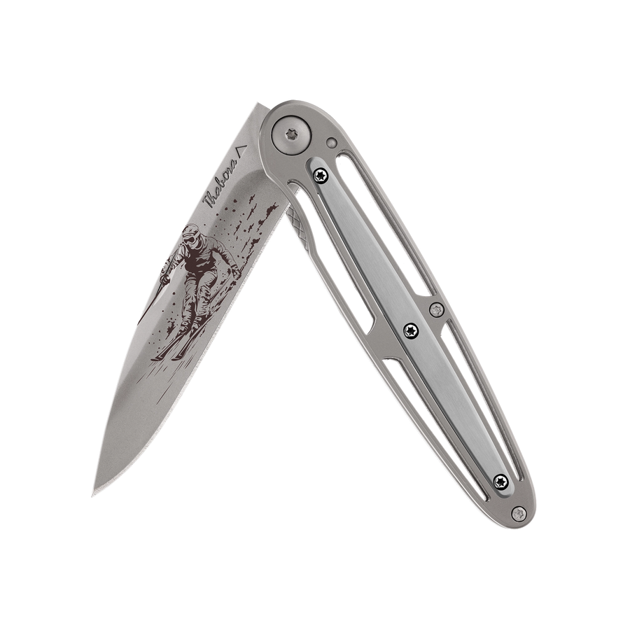 Couteau acier finition titane gris plaquette centrale acier brossé motif «skieur»