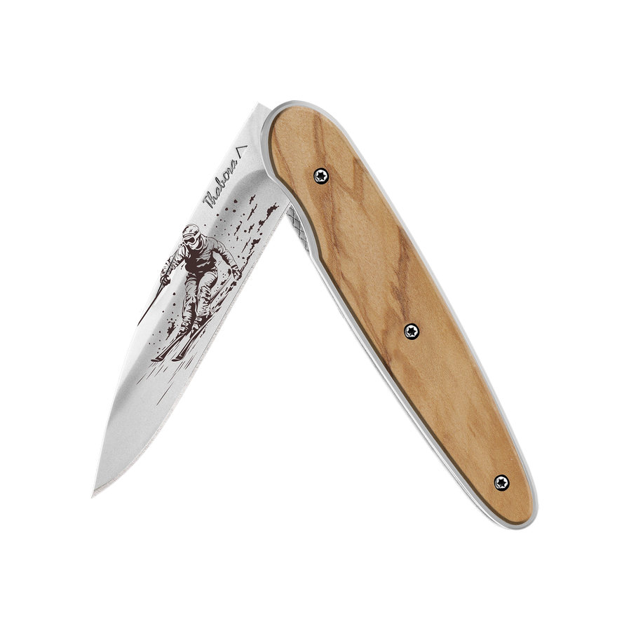 Couteau acier finition brillante plaquette pleine bois clair motif «skieur»