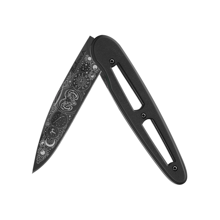 Couteau acier finition titane noir plaquette ajourée résine g10 noir motif «zodiaque bélier»