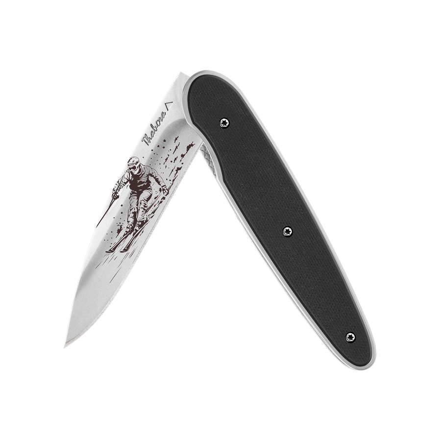 Couteau acier finition brillante plaquette pleine résine g10 noir motif «skieur»