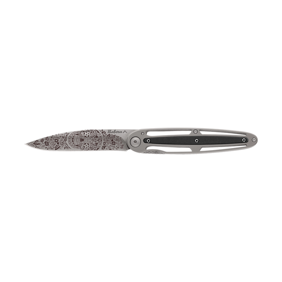 Couteau acier finition titane gris plaquette centrale résine g10 noir motif «tête mexicaine»