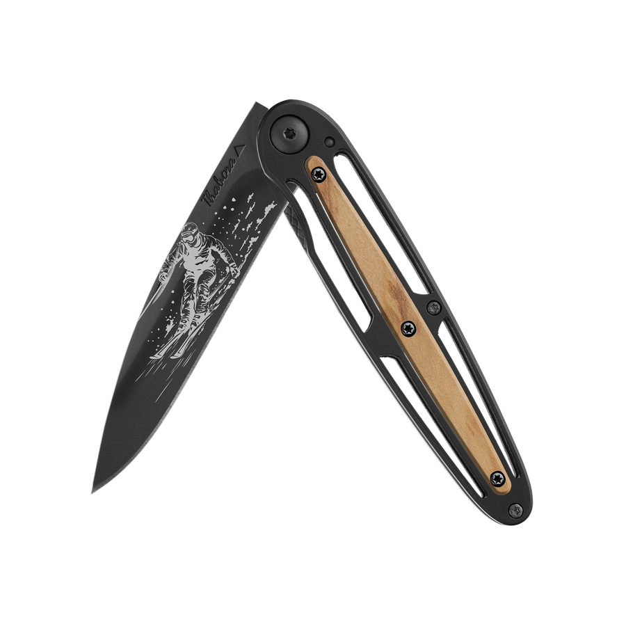 Couteau acier finition titane noir plaquette centrale bois clair motif «skieur»