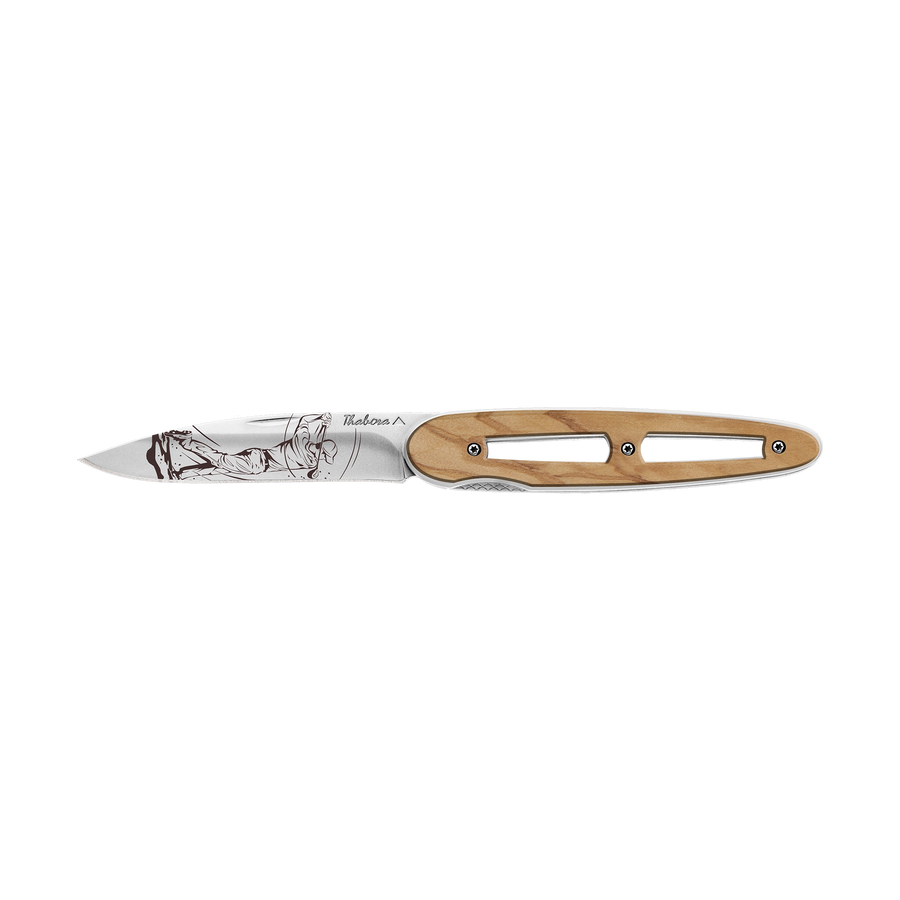 Couteau acier finition brillante plaquette ajourée bois clair motif «golfeur»