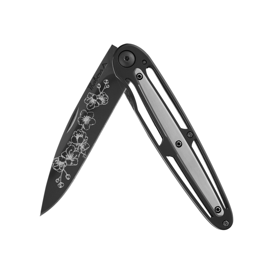 Couteau acier finition titane noir plaquette centrale acier brossé motif «arbre fleuri»