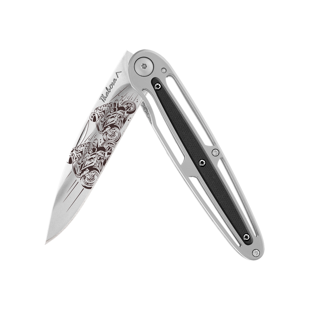 Couteau acier finition titane noir plaquette ajourée résine g10 kaki motif «quad»
