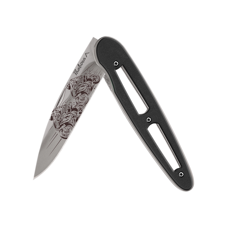 Couteau acier finition titane gris plaquette ajourée résine g10 noir motif «motos de course»
